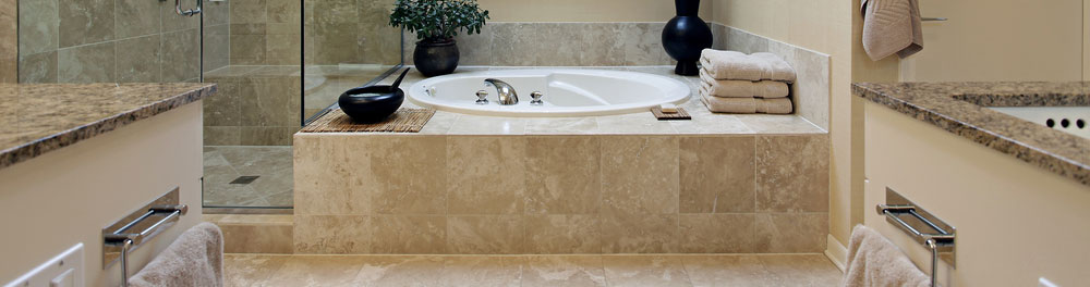 Stone used in a bathroon as countertops, tub and shower surrounds, and flooring.